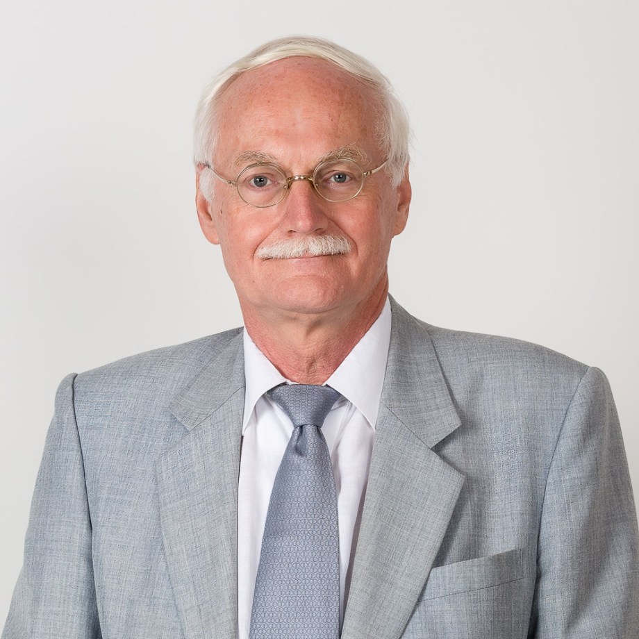 white haired man in a grey suit