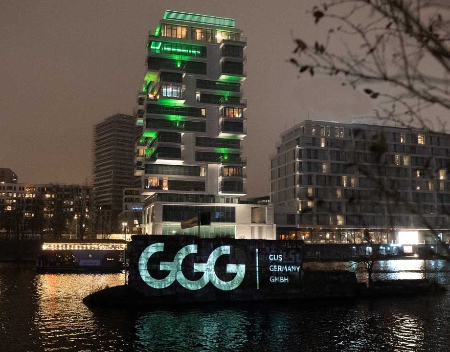 a wall at night, at the waterfront with a logo on it