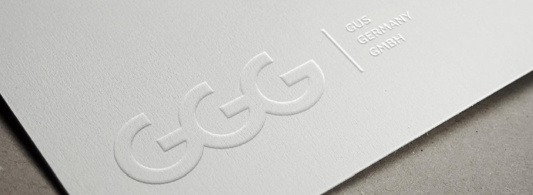 a white paper with embossed logo ggg