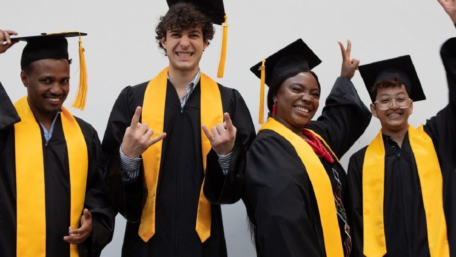 four people just graduated in their suits