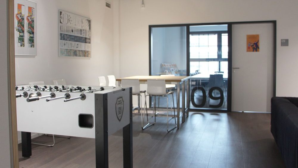 a room with a soccer table and resting area