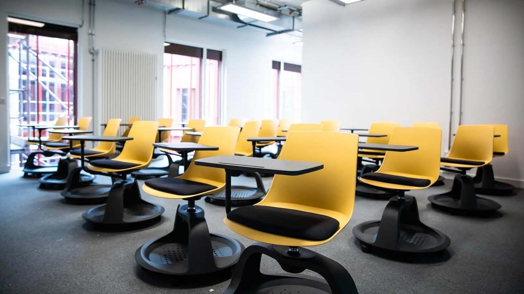 a teaching room full with yellow chairs
